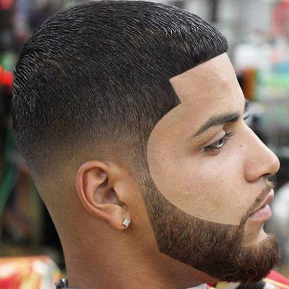 A man with a beard and mustache is looking at the camera.