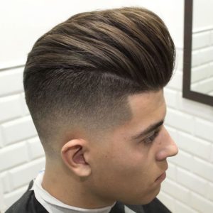 A man with a high fade haircut and a pompadour hairstyle.