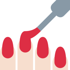 A nail polish bottle being used to paint red nails.